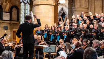 The choir, orchestra and conductor performing at a concert in Southwell Minster.