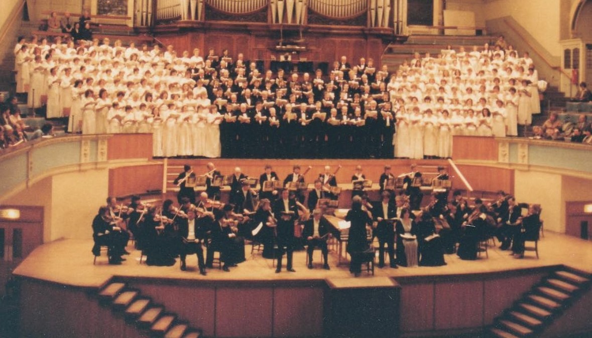 Historical photograph of the choir singing with an orchestra at a concert in the Albert Hall, Nottingham.