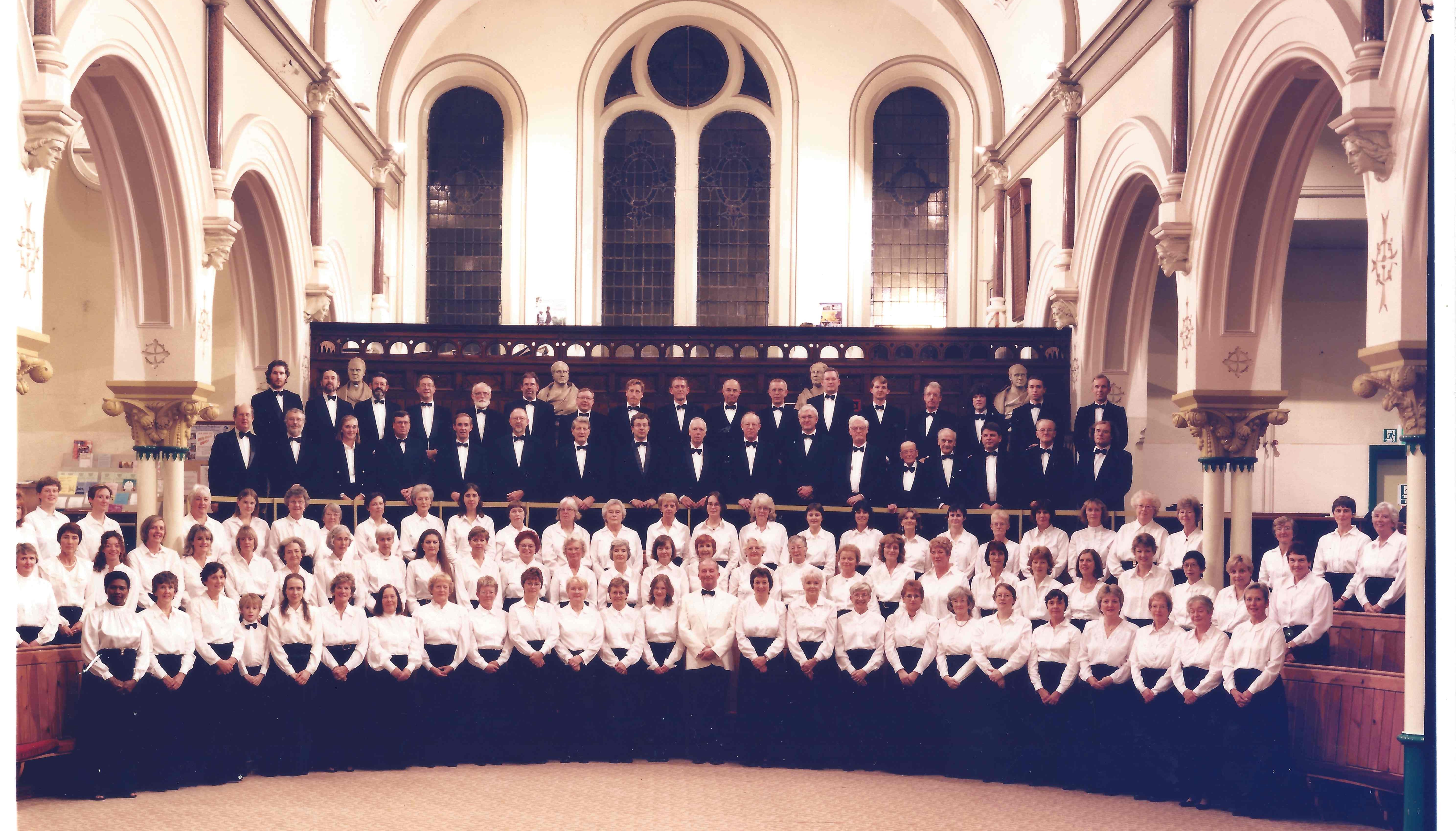 Historical photograph of the choir and conductor, Neil Page, taken at the rehearsal venue at the time.